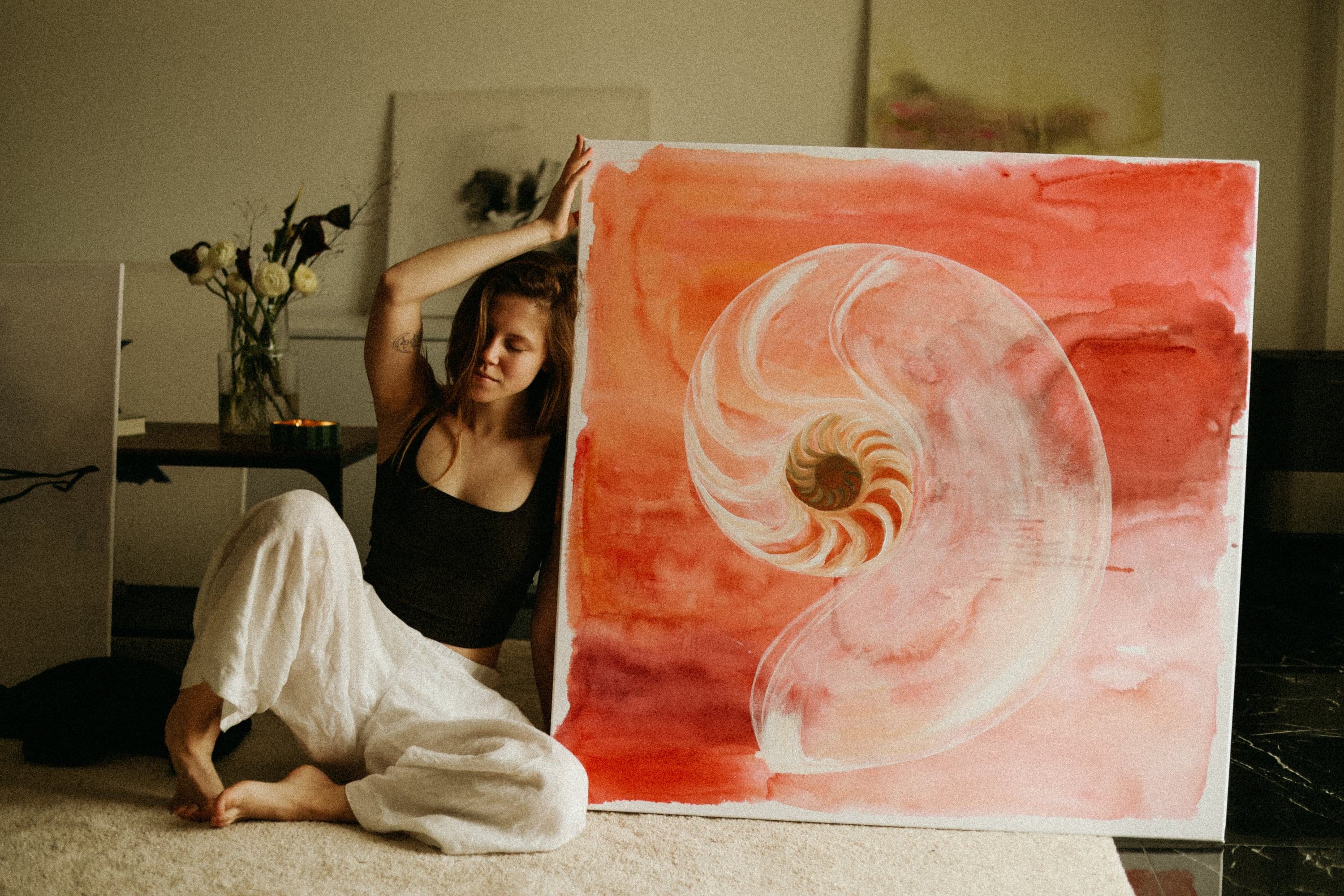 Olha Chechulina in her studio, beside the painting Spiral